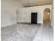 Bright living room with carpeted floors, arched doorways, and natural light creating a cozy atmosphere at 4460 Sw 44Th St, Ocala, FL 34474