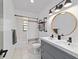 Updated bathroom with dual sinks, modern fixtures, and a shower-tub combination at 4601 Se 18Th Ave, Ocala, FL 34480