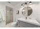 Modern bathroom featuring shower, vanity, and decorative mirror at 4601 Se 18Th Ave, Ocala, FL 34480