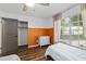 Bright bedroom features natural light, wood floors, a ceiling fan, and a neutral color palette at 4601 Se 18Th Ave, Ocala, FL 34480