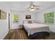 Bright bedroom featuring wood-look flooring and two windows providing ample natural light at 4601 Se 18Th Ave, Ocala, FL 34480