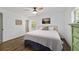 Cozy bedroom featuring wood-look floors, ceiling fan, and neutral paint scheme at 4601 Se 18Th Ave, Ocala, FL 34480