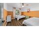 Inviting bedroom with neutral walls, ceiling fan, and wood-look floors at 4601 Se 18Th Ave, Ocala, FL 34480