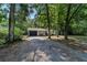 Home shows mature landscaping, a black garage door, black trimmed windows, and a front sitting area at 4601 Se 18Th Ave, Ocala, FL 34480