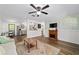 Stylish living area with wood flooring, seamless flow into the kitchen, dining and a decorative fireplace at 4601 Se 18Th Ave, Ocala, FL 34480