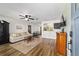 Bright living room with wood floors, a ceiling fan, and an open layout to the kitchen and dining area at 4601 Se 18Th Ave, Ocala, FL 34480