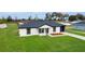 Charming single-story home boasts a well-manicured lawn, a new roof and fresh exterior paint at 5701 Nw 6Th Pl, Ocala, FL 34482