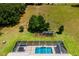 Aerial view of backyard pool and garden including mature trees at 5815 Ne 70Th St, Silver Springs, FL 34488