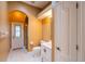 Bright bathroom featuring a white vanity, toilet, tile flooring and access to the shower and backyard at 5815 Ne 70Th St, Silver Springs, FL 34488