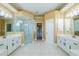 Bright primary bathroom with dual vanities, a walk-in shower, and tile flooring at 5815 Ne 70Th St, Silver Springs, FL 34488