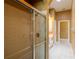 Walk-in shower showcasing glass doors, complemented by a long vanity and tile floors at 5815 Ne 70Th St, Silver Springs, FL 34488