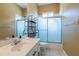 Bathroom featuring vanity, shower-tub combination with patterned glass doors at 5815 Ne 70Th St, Silver Springs, FL 34488