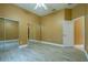 Bedroom with wood-look flooring, ceiling fan and mirrored closet doors at 5815 Ne 70Th St, Silver Springs, FL 34488