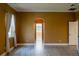 Bedroom featuring wood-look tile flooring, an arched doorway, and a large window with white curtains at 5815 Ne 70Th St, Silver Springs, FL 34488
