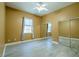 Neutral-toned bedroom with ample natural light, ceiling fan and mirrored closet doors at 5815 Ne 70Th St, Silver Springs, FL 34488