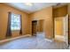 Bedroom with light gray wood-style tile flooring, closet with sliding mirror doors, and view to the outdoors at 5815 Ne 70Th St, Silver Springs, FL 34488