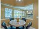 Dining space with a large window offering a view of the pool and kitchen at 5815 Ne 70Th St, Silver Springs, FL 34488