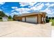 Stunning exterior featuring three-car garage, spacious driveway and well-manicured landscaping at 5815 Ne 70Th St, Silver Springs, FL 34488