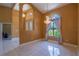 Elegant foyer with tile flooring, arched doorway and a decorative chandelier at 5815 Ne 70Th St, Silver Springs, FL 34488
