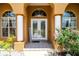 Inviting front entrance featuring white pillars, arch windows, double doors and beautiful landscaping at 5815 Ne 70Th St, Silver Springs, FL 34488
