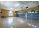 Spacious three-car garage featuring epoxy flooring, with a large arched window for natural light and ventilation at 5815 Ne 70Th St, Silver Springs, FL 34488