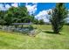 Outdoor garden with raised garden beds and protective netting at 5815 Ne 70Th St, Silver Springs, FL 34488