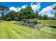 Backyard featuring garden with raised beds and protective netting on a lush green lawn at 5815 Ne 70Th St, Silver Springs, FL 34488