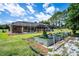 Backyard featuring garden with raised beds and protective netting at 5815 Ne 70Th St, Silver Springs, FL 34488
