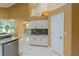 Kitchen with white cabinets and modern appliances is visible from the dining area at 5815 Ne 70Th St, Silver Springs, FL 34488