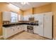 A modern kitchen with stainless steel appliances, white cabinets, and a decorative backsplash at 5815 Ne 70Th St, Silver Springs, FL 34488