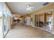 Spacious living room featuring tiled flooring and multiple sliding doors that lead to an outdoor living area at 5815 Ne 70Th St, Silver Springs, FL 34488