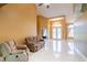 Bright living room boasts high ceilings and light tile floors, bathed in natural light from the front door and windows at 5815 Ne 70Th St, Silver Springs, FL 34488