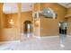 Large living room exhibiting unique archways, high ceilings, and tile floors, offering a spacious and bright atmosphere at 5815 Ne 70Th St, Silver Springs, FL 34488