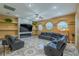 Spacious living room with a stone fireplace, built-in shelves, and comfortable seating at 5815 Ne 70Th St, Silver Springs, FL 34488