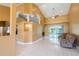 An open-concept living space showcases high ceilings, tile flooring, and pool views through sliding glass doors at 5815 Ne 70Th St, Silver Springs, FL 34488