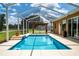 A stunning enclosed in ground pool features an outdoor pergola and lounging area for relaxation at 5815 Ne 70Th St, Silver Springs, FL 34488