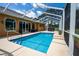 A beautiful enclosed pool with a hot tub in the backyard and an outdoor lounging area at 5815 Ne 70Th St, Silver Springs, FL 34488
