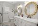 Elegant bathroom featuring a double vanity, granite countertops, and decorative mirrors at 6573 S Magnolia Ave, Ocala, FL 34471