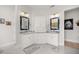 Elegant bathroom featuring dual vanities, stylish mirrors, and marble countertops at 6573 S Magnolia Ave, Ocala, FL 34471