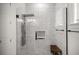Modern bathroom featuring a walk-in shower, a rain shower head, and sleek tilework at 6573 S Magnolia Ave, Ocala, FL 34471