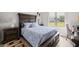 Beautifully decorated bedroom with a large window and a stately, dark-wood frame bed set at 6573 S Magnolia Ave, Ocala, FL 34471