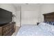 Comfortable bedroom with a large closet, a wood-frame bed set, and a television for relaxing at 6573 S Magnolia Ave, Ocala, FL 34471