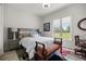 Comfortable bedroom featuring a bed, side tables, and a window with a backyard view at 6573 S Magnolia Ave, Ocala, FL 34471