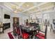 Elegant dining room with a large fireplace, open layout, coffered ceilings, and easy access to the kitchen at 6573 S Magnolia Ave, Ocala, FL 34471