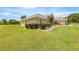 Beautifully landscaped home featuring manicured bushes and a lush green lawn at 6573 S Magnolia Ave, Ocala, FL 34471