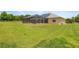 Lush backyard with a screened-in pool and manicured lawn offers serene outdoor living at 6573 S Magnolia Ave, Ocala, FL 34471