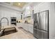 Modern kitchen with stainless steel refrigerator, breakfast bar, double oven, and stylish fixtures at 6573 S Magnolia Ave, Ocala, FL 34471