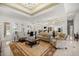 Bright living area with tile flooring, coffered ceilings, and open layout perfect for entertaining guests at 6573 S Magnolia Ave, Ocala, FL 34471