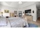 Well-lit main bedroom featuring a fireplace, TV, and neutral decor at 6573 S Magnolia Ave, Ocala, FL 34471