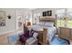 Bright main bedroom featuring a large bed, bench, and access to the outdoor living area at 6573 S Magnolia Ave, Ocala, FL 34471
